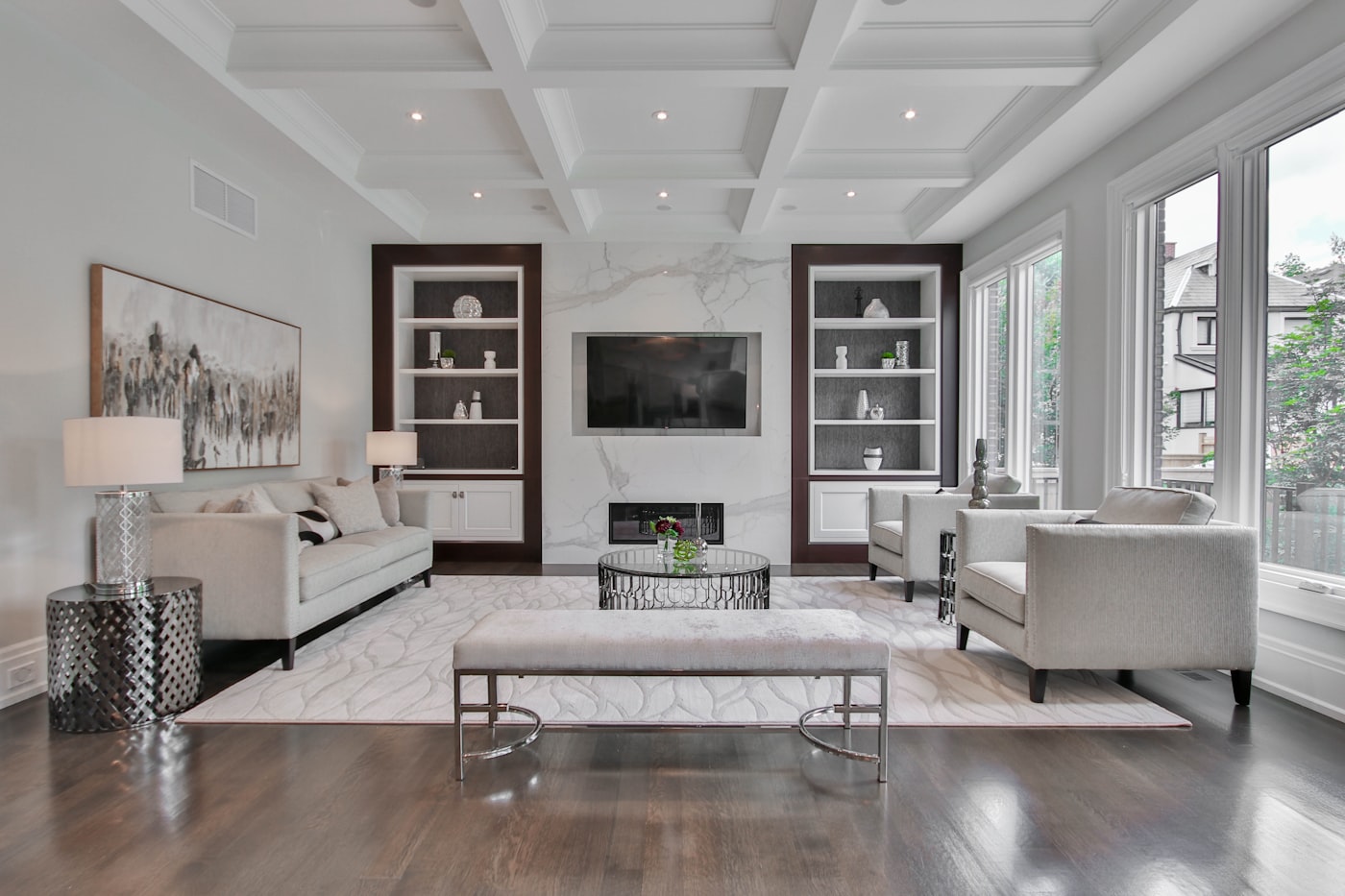 A living room with built-in shelving and a feature TV wall